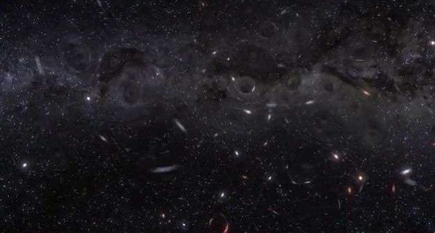 Invisible black holes warp the space time around them in the center of a busy, dense cluster of stars.