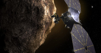 Illustration of a space probe with two sets of circular solar panels in the foreground of a small, rocky body.