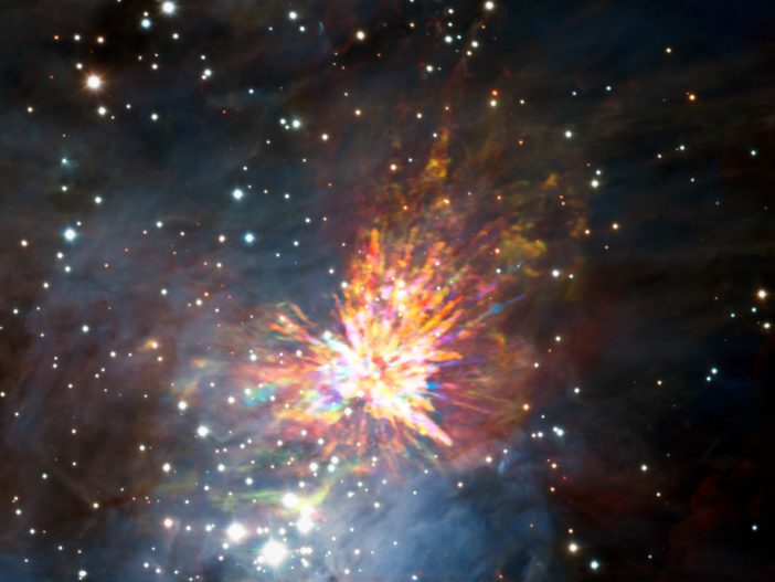Composite image showing an explosive outflow that looks like a firework set against a backdrop of stars.
