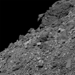 Grayscale image of a rocky surface.