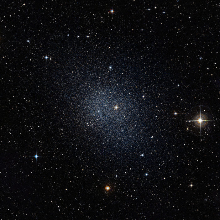 Photograph of an extremely faint galaxy, visible as a dim collection of stars.