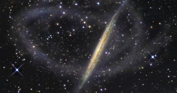 Photo of an edge-on galaxy encircled by a faint stream of stars.