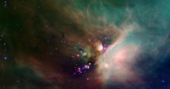 Spitzer photograph of a dramatic nebula surrounding bright point sources.