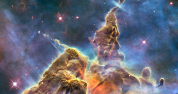 Photograph of a towering molecular cloud with streams of dust extending from cloud columns.