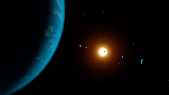 Illustration of a large, watery planet in the foreground and an additional 5 planets in the background around a bright star.