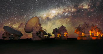 More than 10 radio telescopes point toward the sky in front of the Milky Way