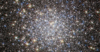 A globular cluster, densest at the center, with stars of several different colors