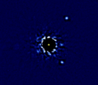 Four bright circles appear at varying distances from a central star
