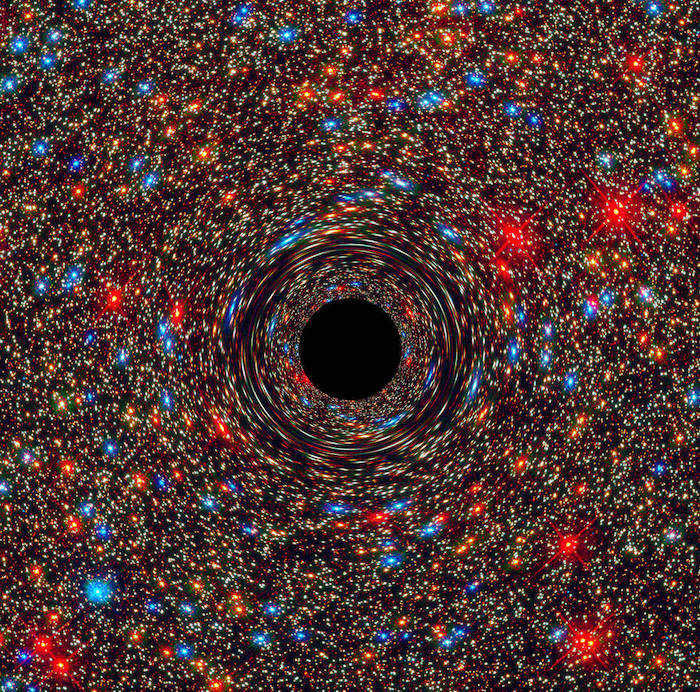 Simulated image showing a foreground black hole warping spacetime around it, with a background of red and blue stars in the center of a galaxy.