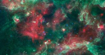 intricate tendrils and clumps of gas and dust stretch across a star-forming region dotted with young stars