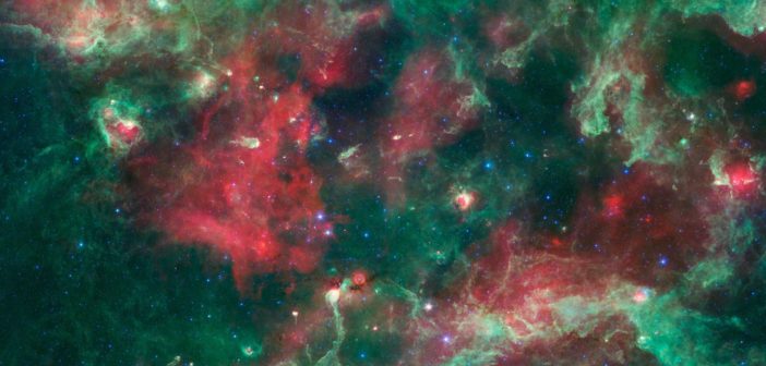 intricate tendrils and clumps of gas and dust stretch across a star-forming region dotted with young stars