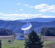 photograph of the green bank telescope in front of rolling mountains