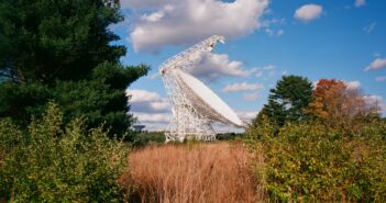 photograph of the green bank telescope in front of rolling mountains