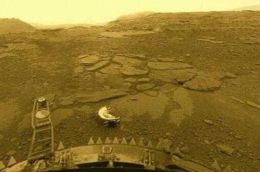 the rocky dry surface of venus with a bit of the venera lander at the bottom of the image