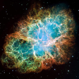 Crab Nebula; an extended structure containing filaments of different colors (representing different elements)