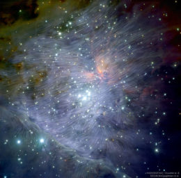 infrared image of the Orion star-forming region with a map of magnetic field lines on top