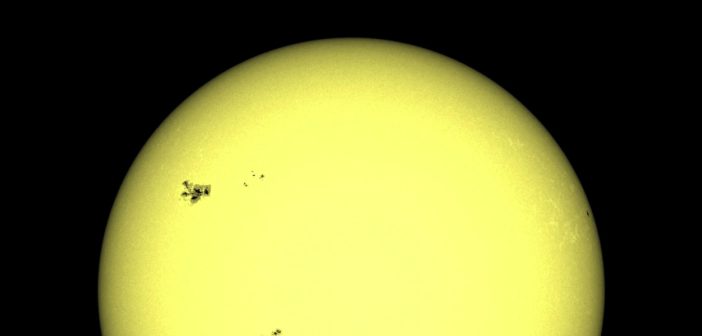 an image of the Sun's disk with a large group of sunspots