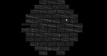 photograph of a telescope's field of view with numerous bright satellite trails cutting across the image