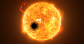 An illustration of an opaque planet transiting in front of a star. The planet is surrounded by a comet-like coma of darker material.
