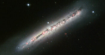 A photograph of a galaxy which appears in the foreground as a diagonal line because of the edge-on viewing geometry.