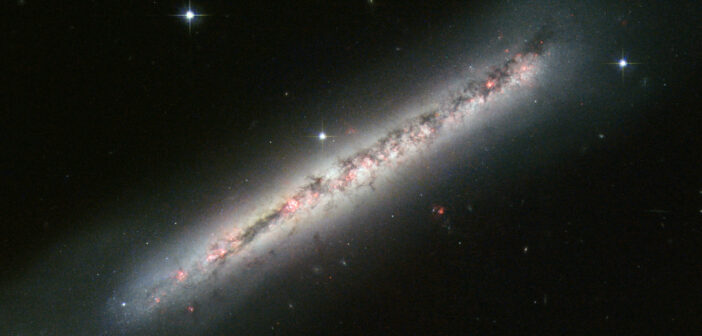 A photograph of a galaxy which appears in the foreground as a diagonal line because of the edge-on viewing geometry.