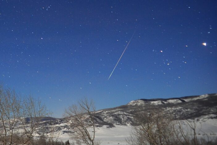 Photograph of a meteor streaking across the night sky