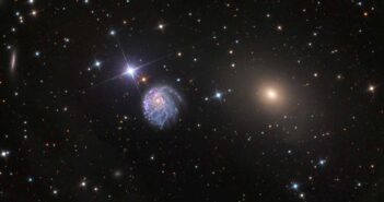 zoomed-out view of a spiral galaxy and an elliptical galaxy