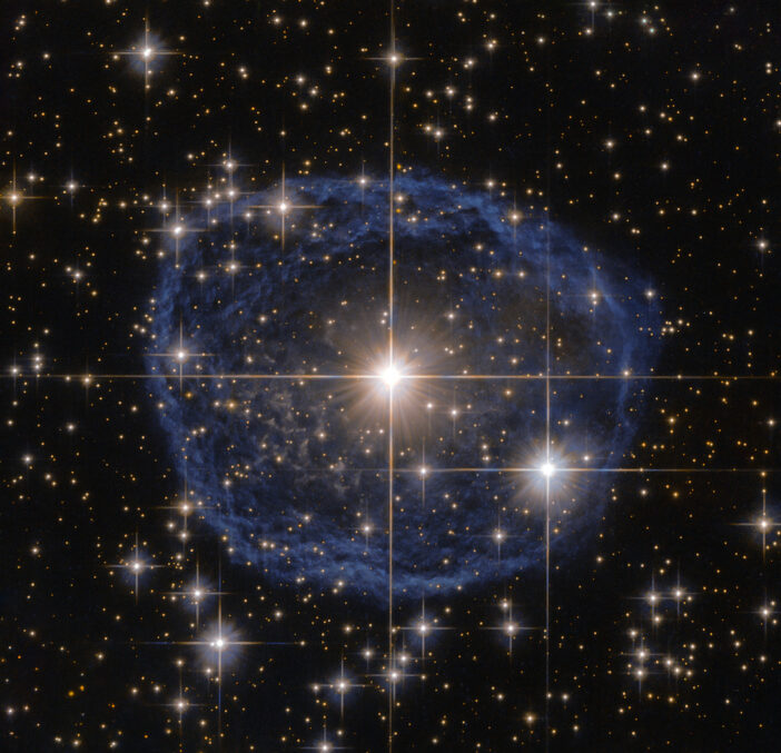 Hubble image of a star surrounded by a blue nebula