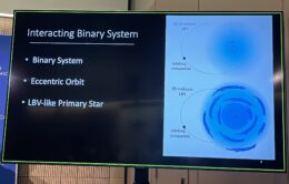 Slide titled "interacting binary system" with bullet points reading "binary system, eccentric orbit, and LBV-like primary star." A graphic to the right of the text has two panels, one with a quiescent LBV and one with an outbursting LBV.