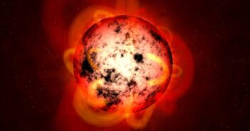 An illustration of an M-dwarf star covered in starspots