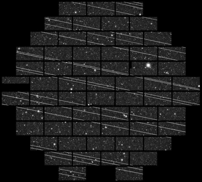 A photograph of stars and long, horizontal, bright streaks caused by satellites.