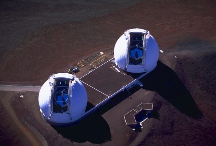 An aerial photograph looking down on two large telescopes.
