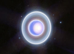 A photograph of a blue-purple sphere surrounded by concentric white rings.