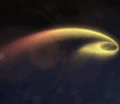 A spiral of bright material circling a black core.