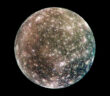 A photograph of a heavily cratered moon on a black background.