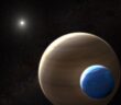 Illustration of a giant planet with a large moon orbiting a distant star