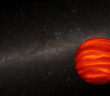 A glowing orange sphere set against a background image of the Milky Way's disk of stars.