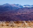 radio antennae in front of a mountain background