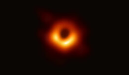 A photograph of an orange ring surrounding a dark center.