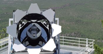 A photograph of a telescope opened at dusk.