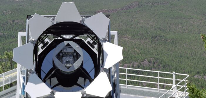 A photograph of a telescope opened at dusk.