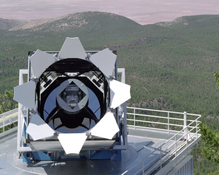 A photograph of a telescope opened at dusk.