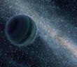 A rendering of a Jupiter-like planet floating in front of a galaxy.