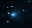 A photograph showing a fuzzy comet coma and some streaked stars alongside.
