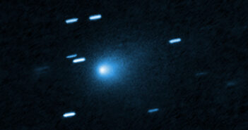 A photograph showing a fuzzy comet coma and some streaked stars alongside.
